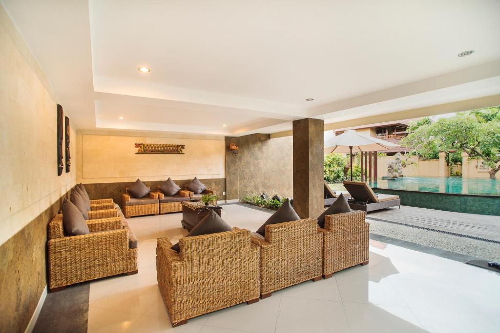 a living room with couches and a swimming pool at Sri Phala Resort & Villa in Sanur