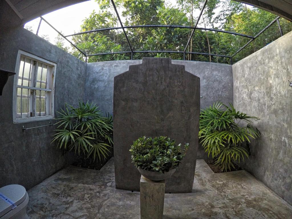 a courtyard with plants and a glass roof at The Horizon Hill Top Villa in Unawatuna