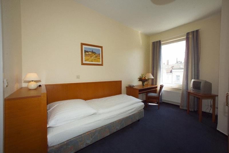 Postel nebo postele na pokoji v ubytování Hotel Terminus am Hauptbahnhof & ZOB