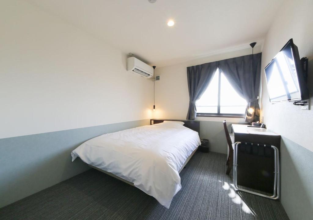 Postel nebo postele na pokoji v ubytování Hotel Taiyo Nouen Furumitsu