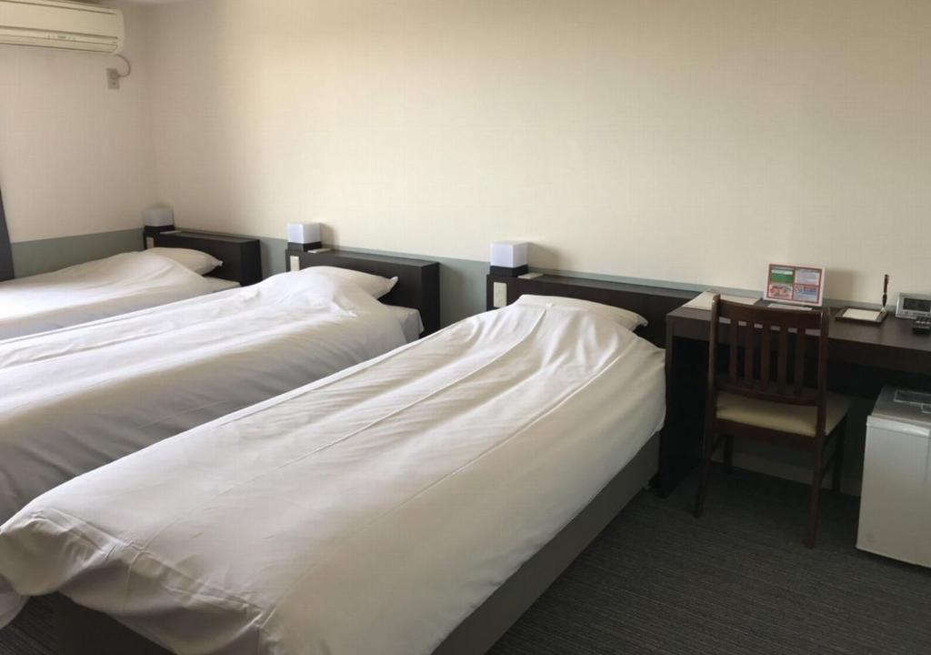 Postel nebo postele na pokoji v ubytování Hotel Taiyo Nouen Furumitsu