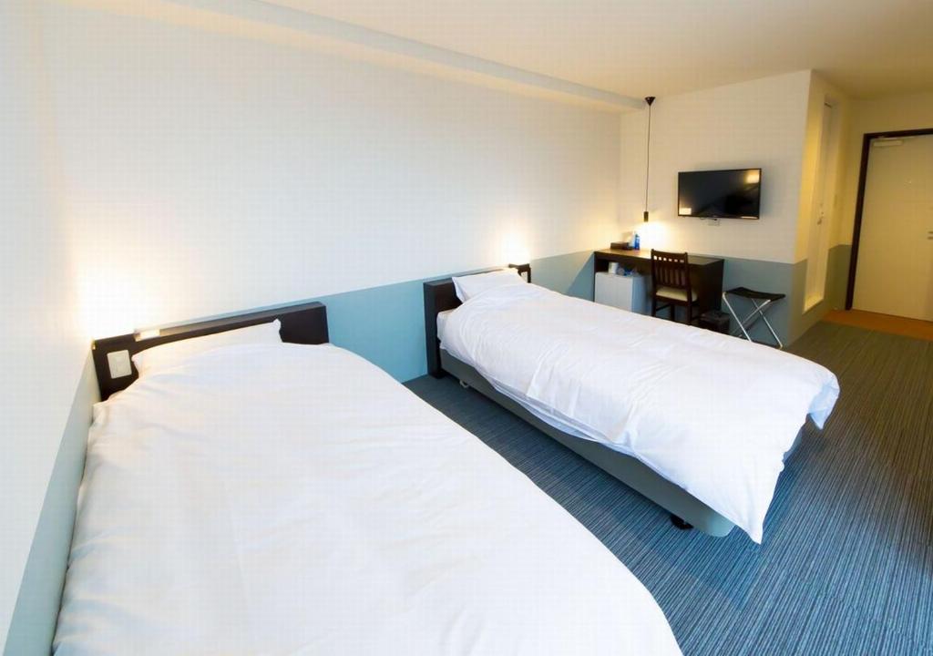 Postel nebo postele na pokoji v ubytování Hotel Taiyo Nouen Furumitsu