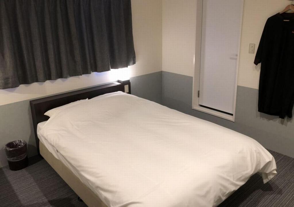 Postel nebo postele na pokoji v ubytování Hotel Taiyo Nouen Furumitsu