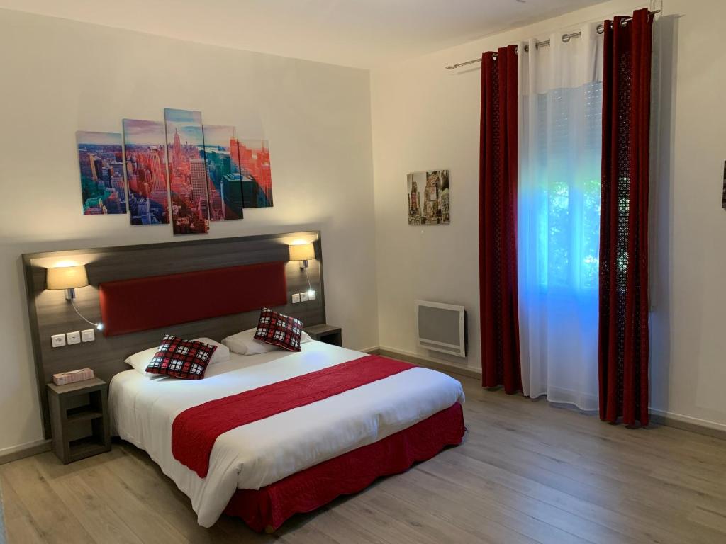 a bedroom with a large bed with red curtains at Les Rives du Plantié in Le Temple-sur-Lot