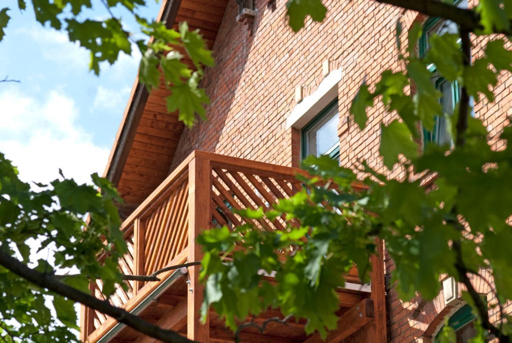 a wooden deck on the side of a building at ASGARD Ferienwohnungen in Thale