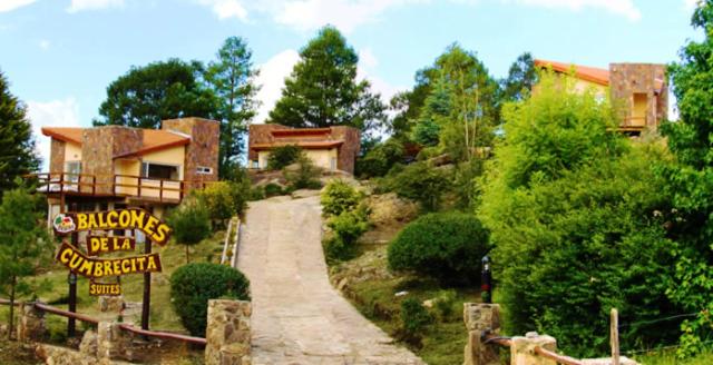 a house on a hill with a sign in front of it at Balcones de La Cumbrecita in La Cumbrecita