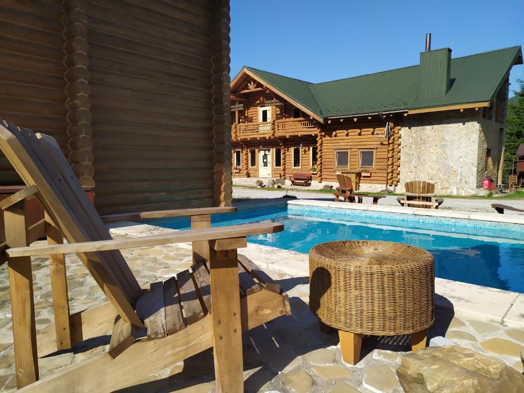 a house with a swimming pool and a house at Hotel Khatky Ruslany in Vorokhta