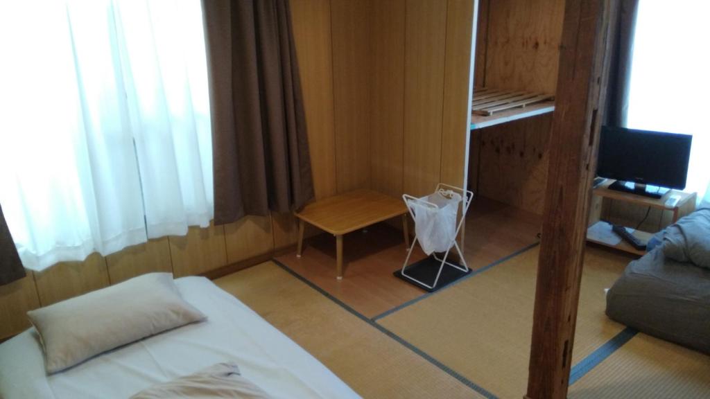 a small room with a couch and a table at Ryokan Nakadaya in Tokyo