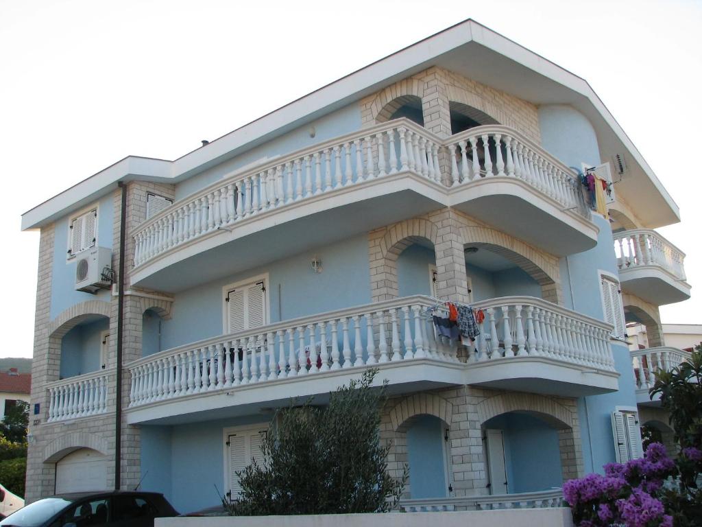 a building with a balcony on the side of it at Apartments Golubić in Sveti Petar