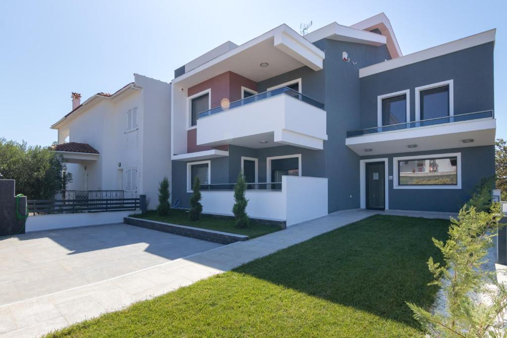 a large house with a yard in front of it at L&S house in Nikiti