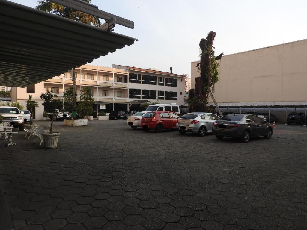 un estacionamiento con autos estacionados frente a un edificio en Hotel Bruggemann, en Florianópolis