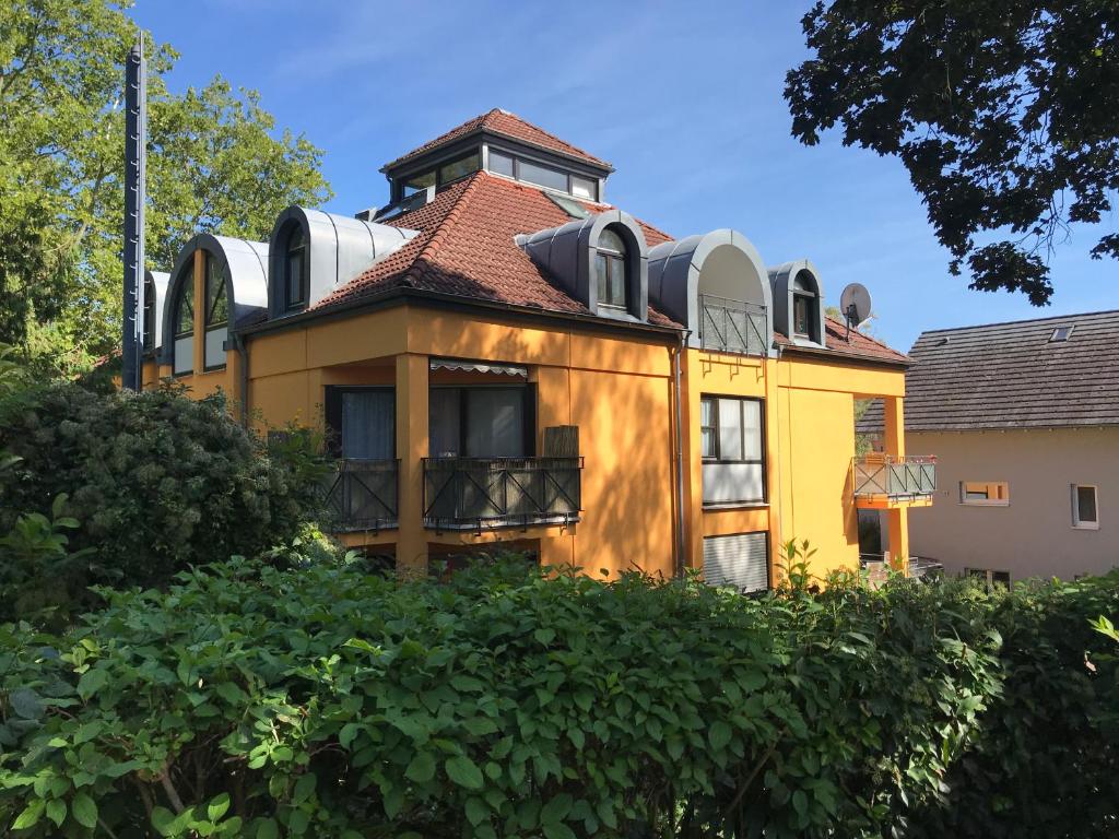 a yellow house with a tower on top of it at Maisonette am Belchen in Bad Krozingen