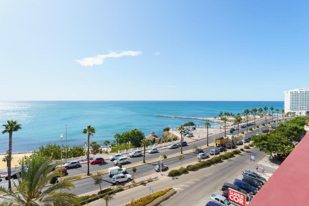 uma vista para um parque de estacionamento e para o oceano em Spacious Beachfront Flat with Sea Views and Private Indoor Parking em Benalmádena