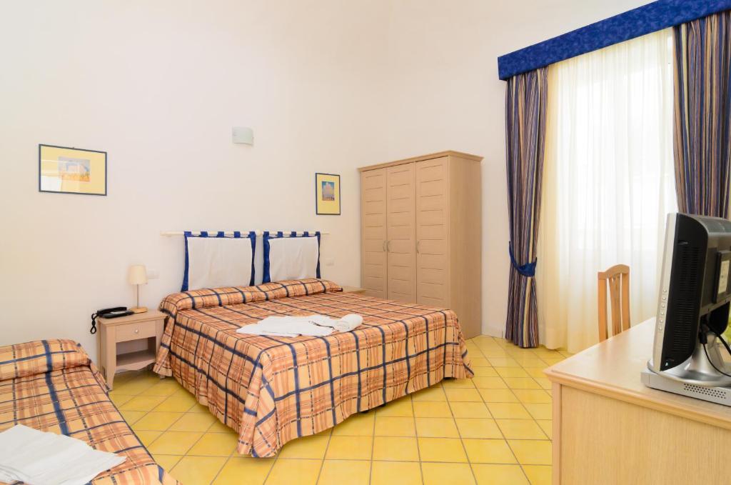 Katil atau katil-katil dalam bilik di Albergo Villa Giusto