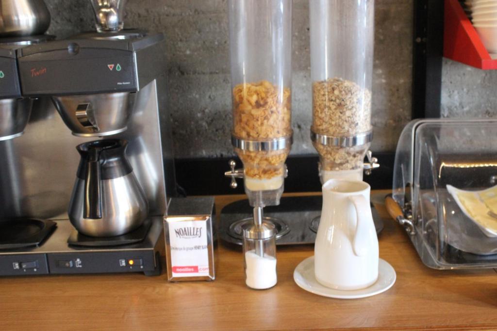 a counter with a coffee maker and a blender at Hotel le Corbusier in Marseille