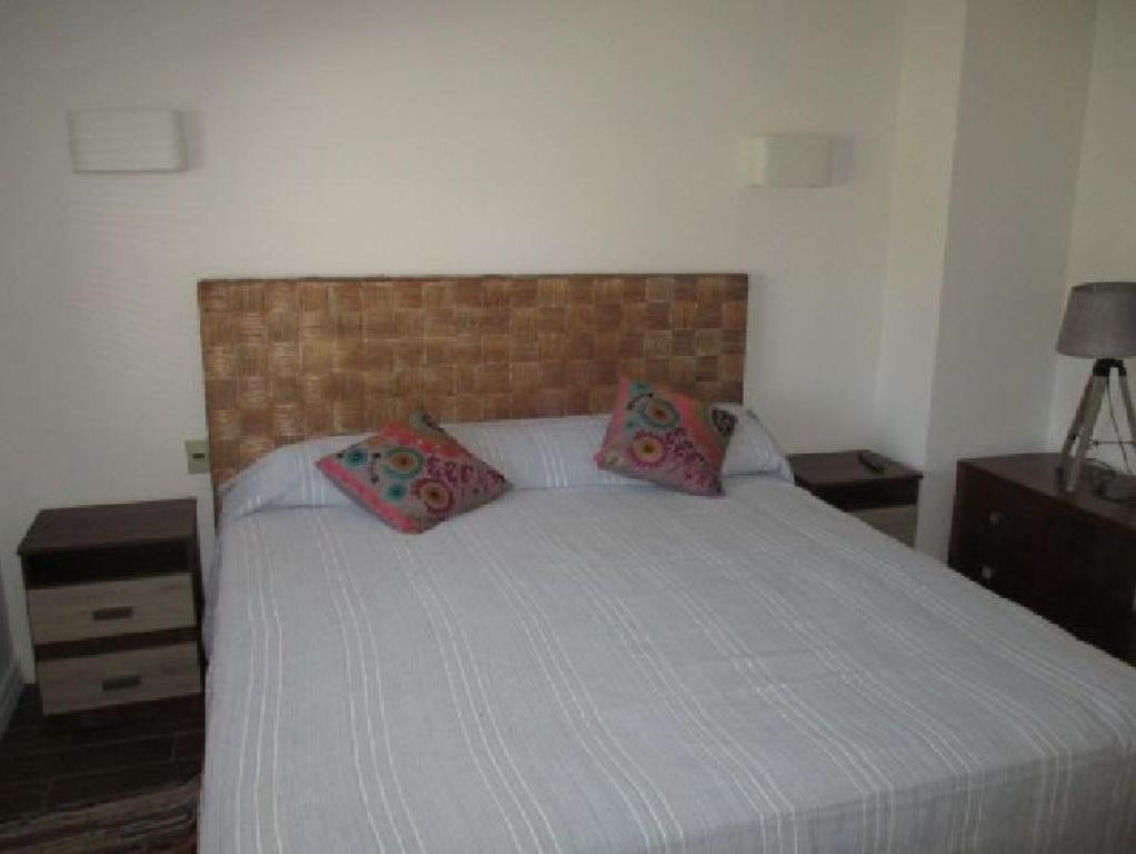 a bedroom with a bed with two pillows on it at Norus Las Tacas in Las Tacas