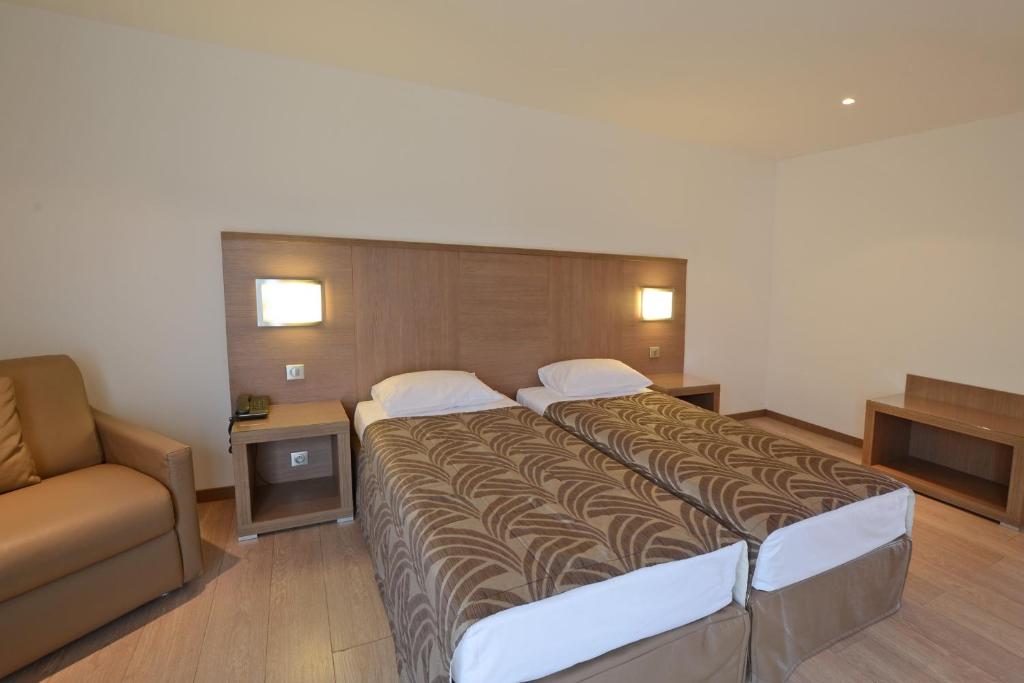 Postel nebo postele na pokoji v ubytování Calvi Hôtel