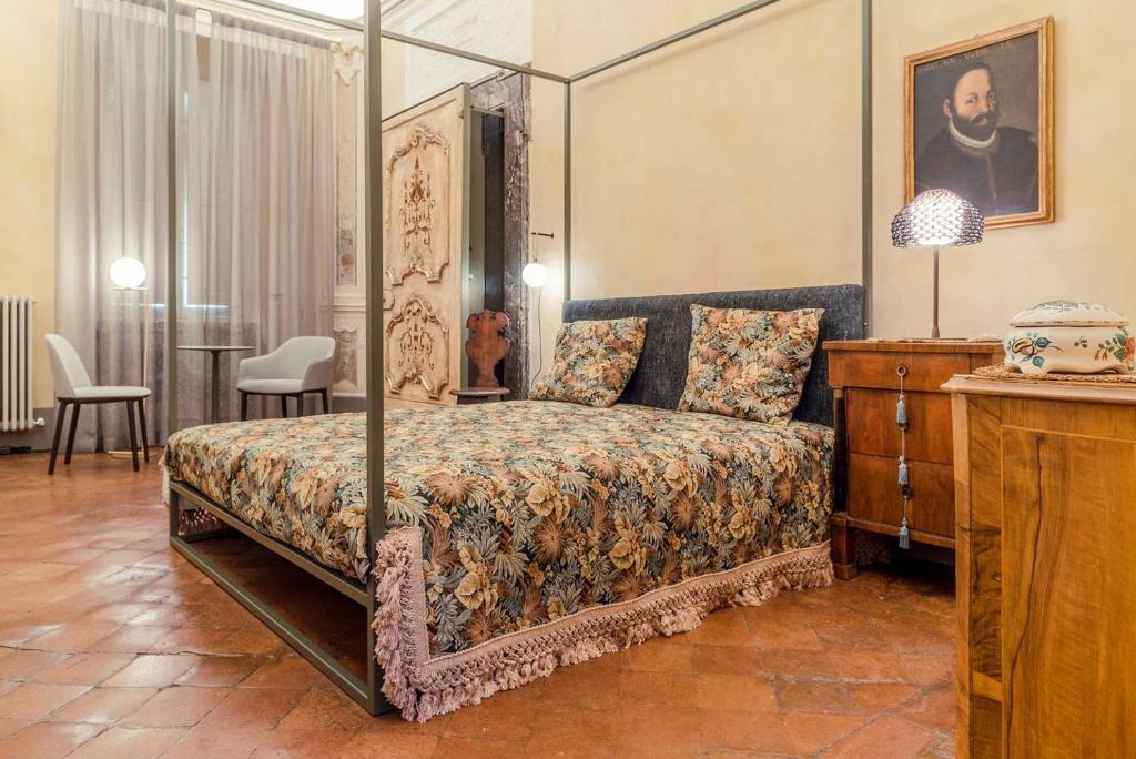 a bedroom with a bed with a canopy at Boutique Apartment Urbino in Urbino