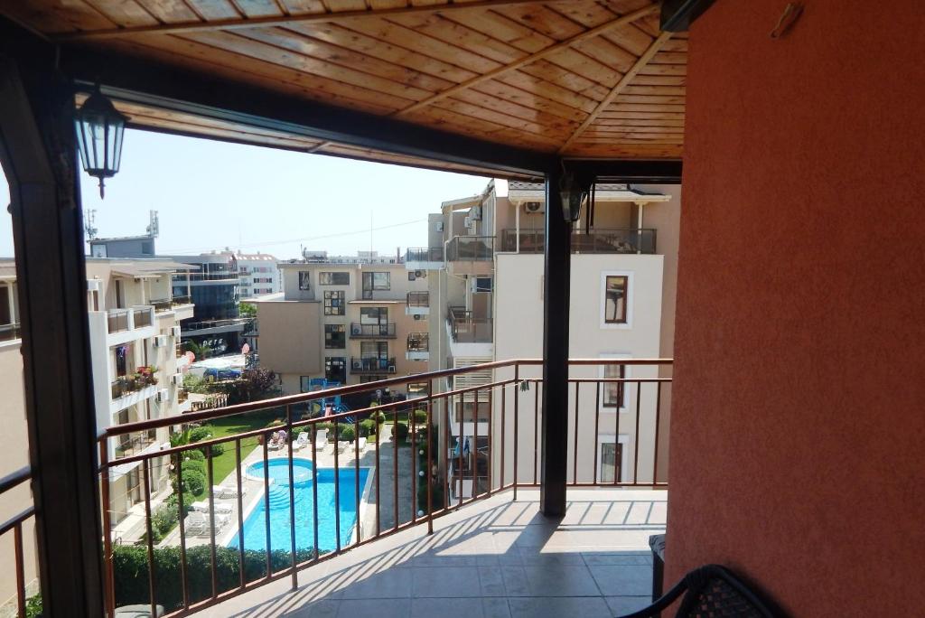 a balcony with a view of a pool and buildings at Dunav Apt.3 in Ravda