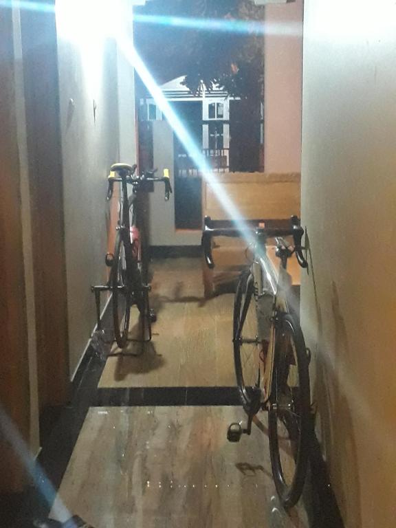 two bikes parked in a hallway with the light shining on them at The New Orlinds Guest House in Wonosari