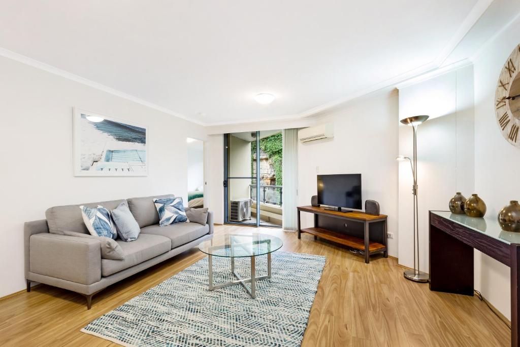a living room with a couch and a glass table at Inner city retreat in Pyrmont 1 bdrm with Car space - 28 Mill in Sydney