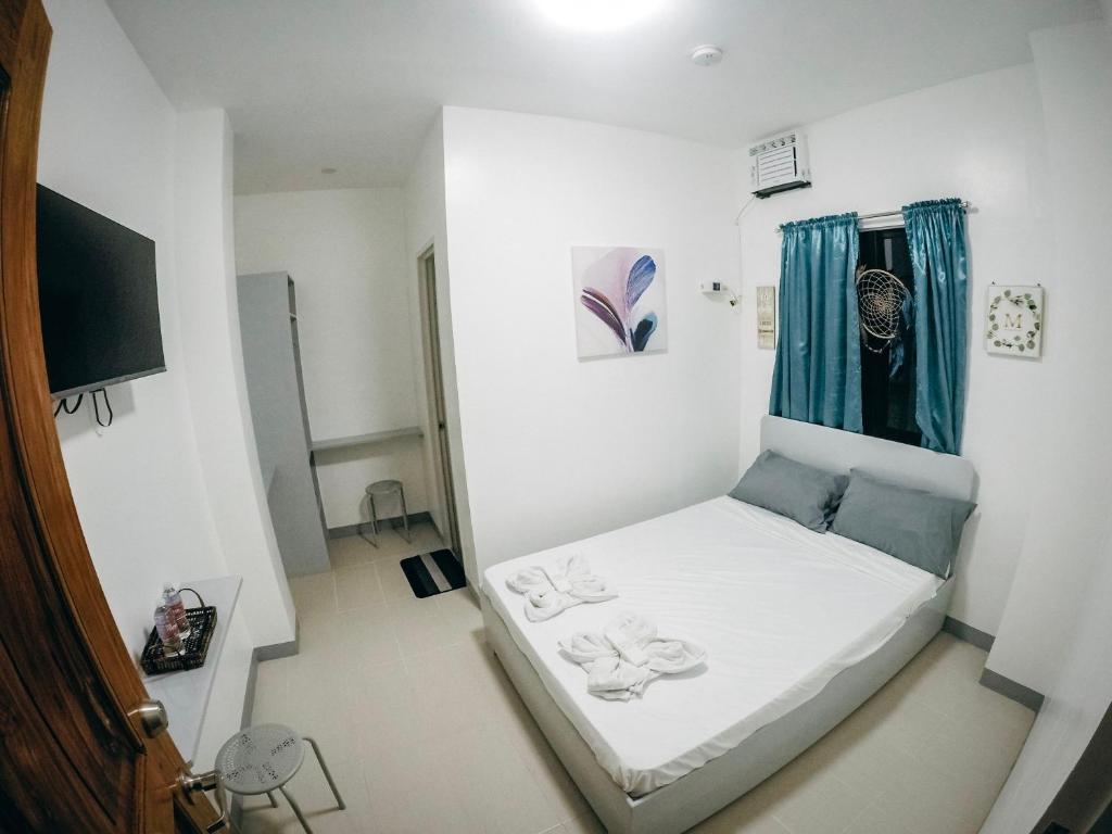 Postel nebo postele na pokoji v ubytování Bulusan Tourist Inn