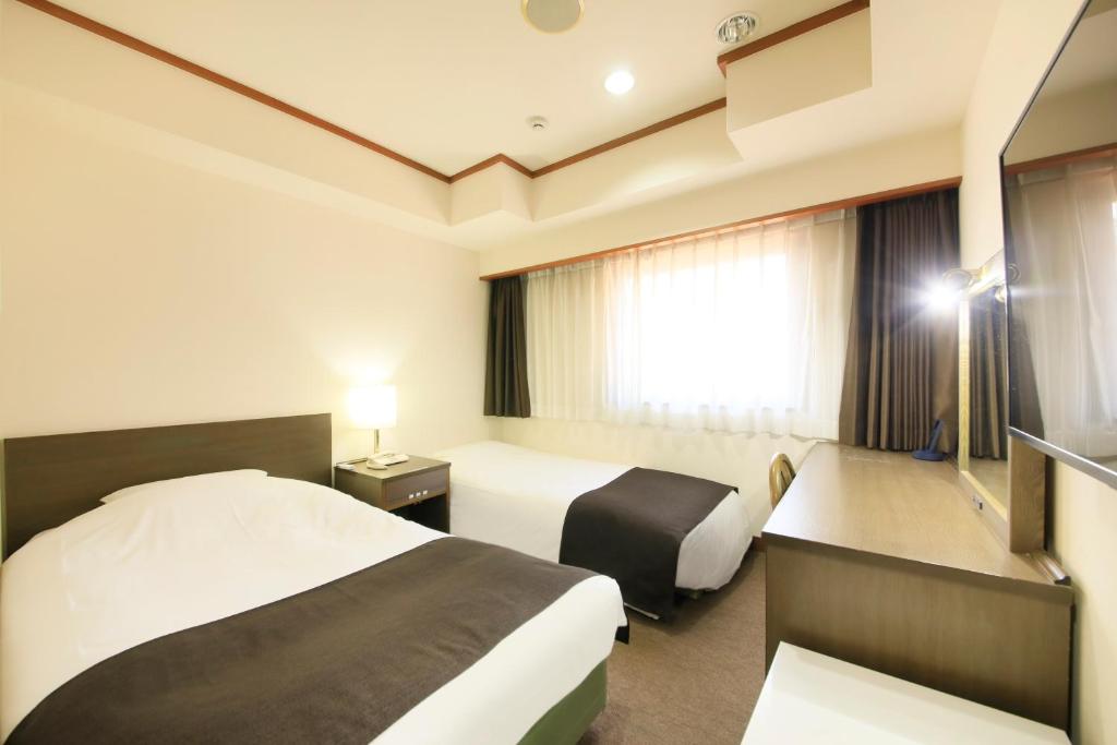 Postel nebo postele na pokoji v ubytování Maple Inn Makuhari