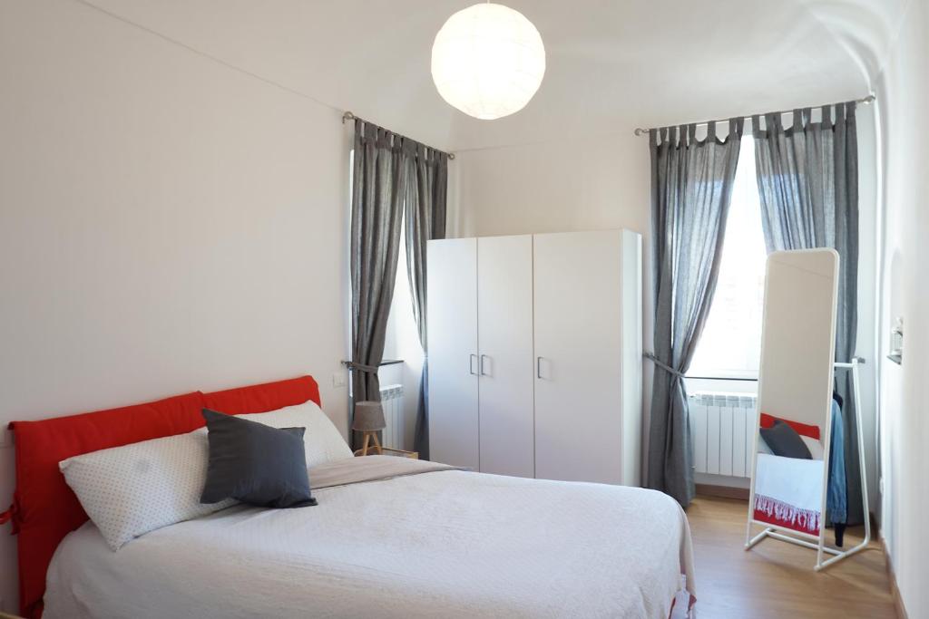 a bedroom with a large bed and a white cabinet at La Piazzetta in Bordighera