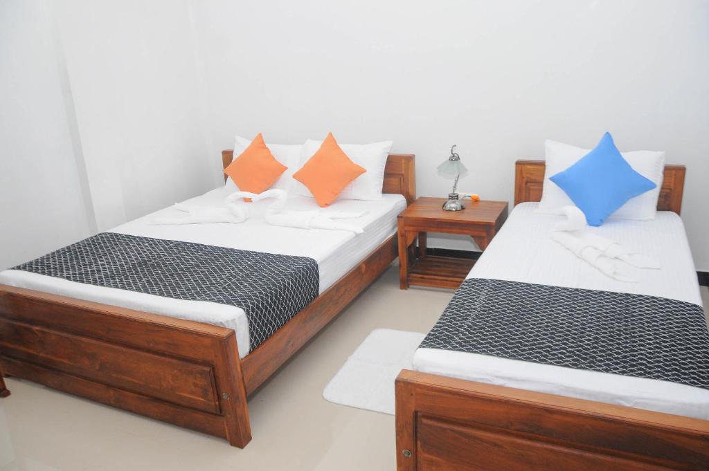 Postel nebo postele na pokoji v ubytování Restwell Homestay