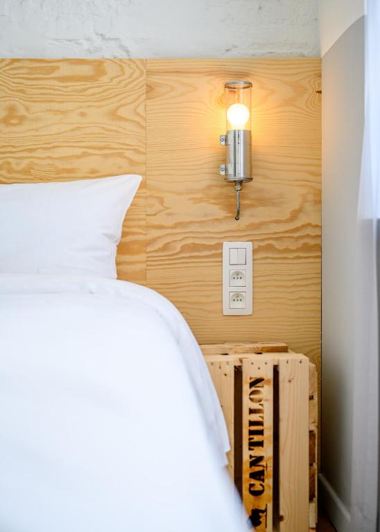 Postel nebo postele na pokoji v ubytování Hotel La Grande Cloche
