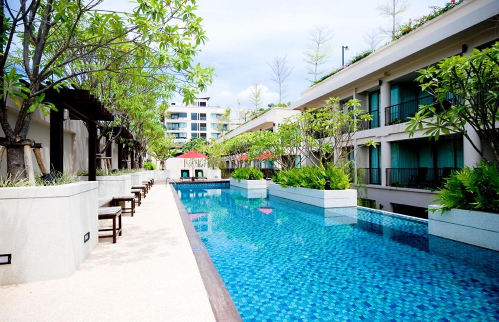 an infinity pool at a hotel in singapore at Tara Mantra Cha-Am Resort in Cha Am