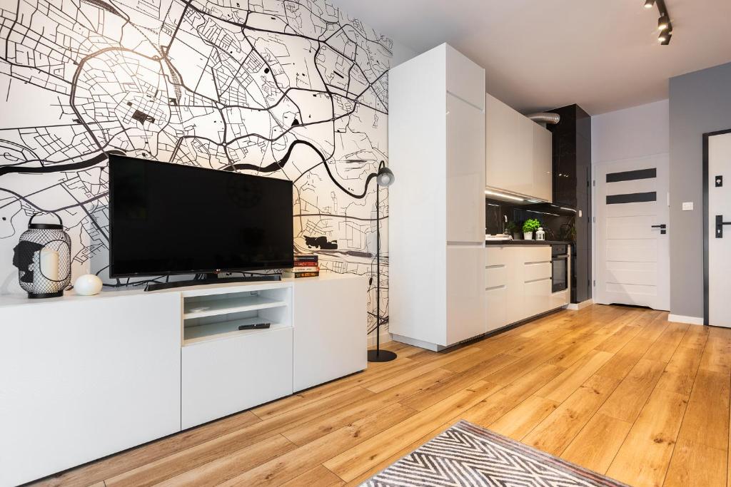 a living room with a large flat screen tv at NOVUM Apartment in Krakow