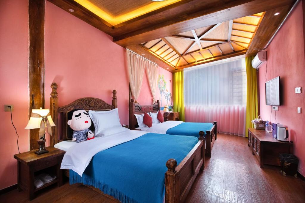 Postel nebo postele na pokoji v ubytování The Ritz-Man Boutique Inn Lijiang