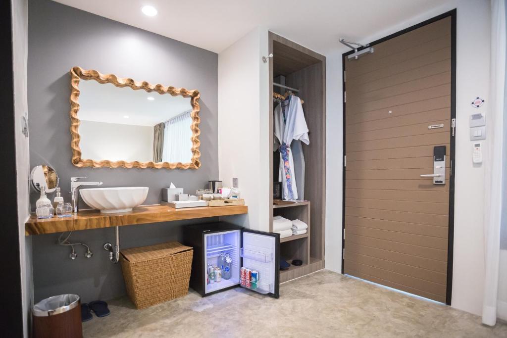 a bathroom with a sink and a mirror at Deevana Krabi Resort in Ao Nang Beach