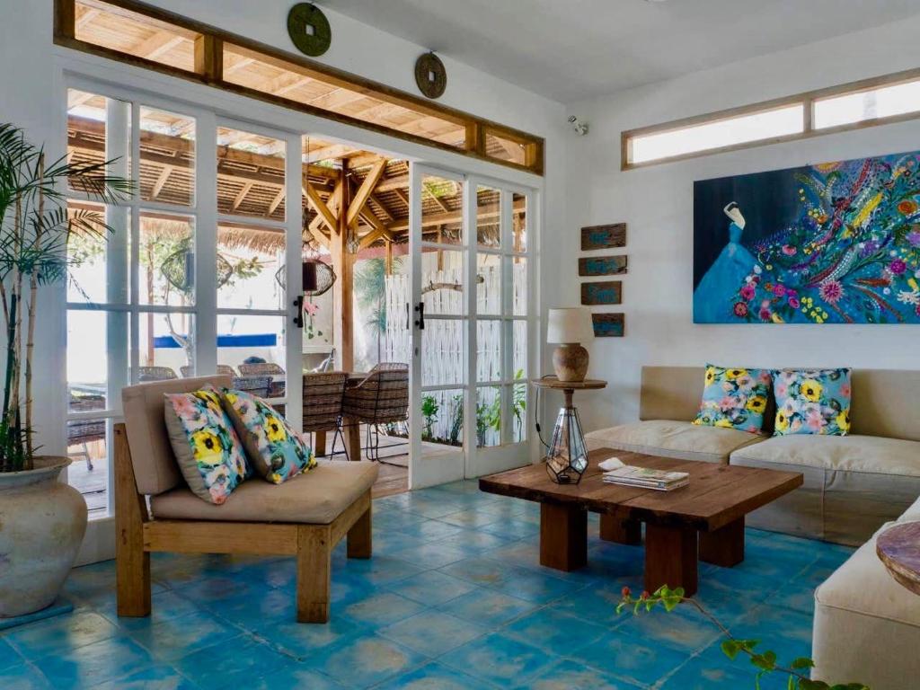a living room with a couch and a table at Serenity Luxurious Beachfront Villa & Spa with private Infinity Pool, 8 Guests in Gili Air
