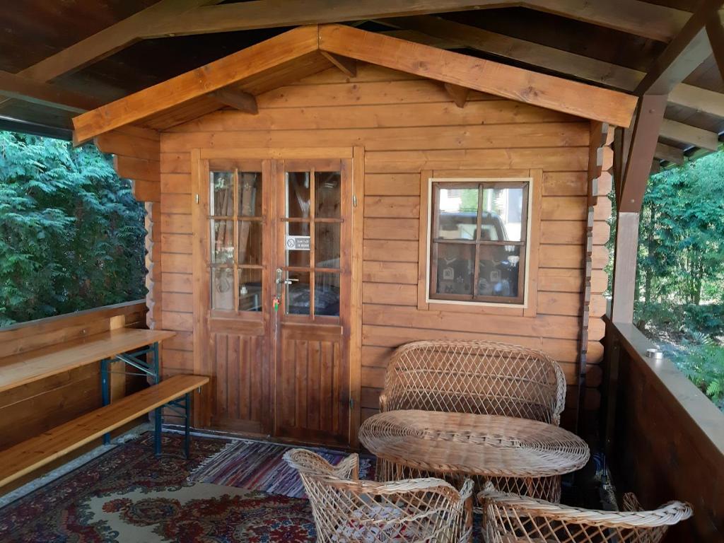 a small cabin with a chair and a window at Cottage Košice with heating - Chatka Košice s vykurovaním in Košice