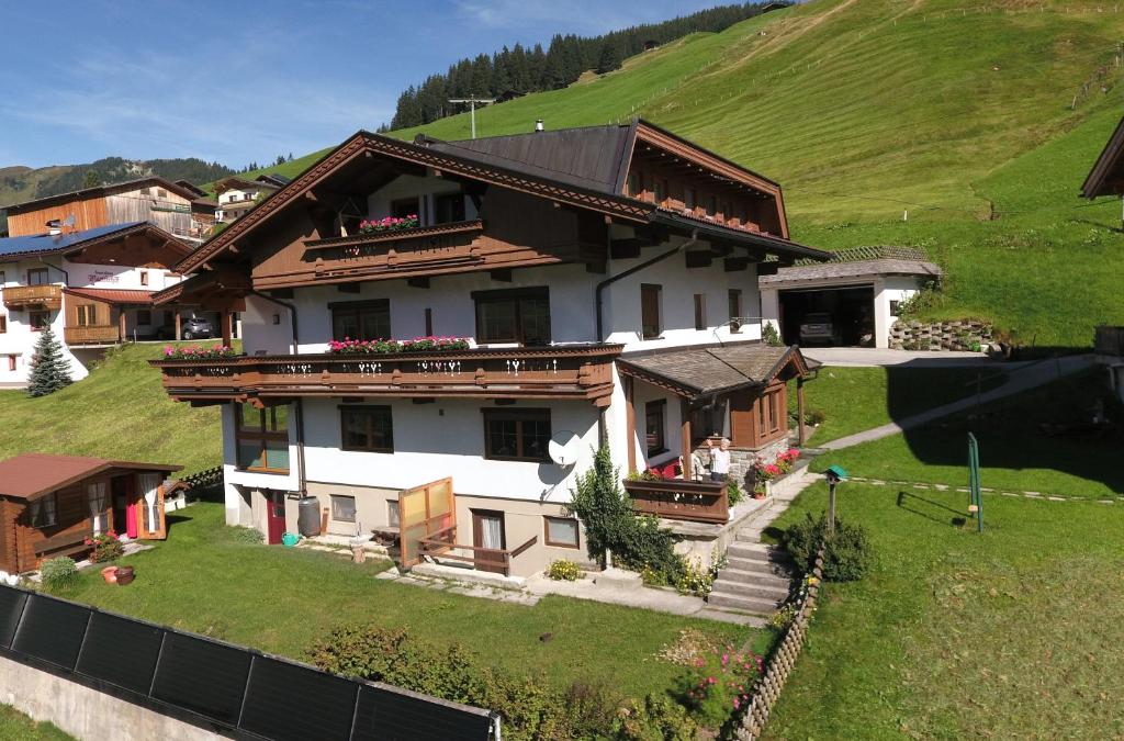 a house on top of a green hill at Scheurerhof in Tux