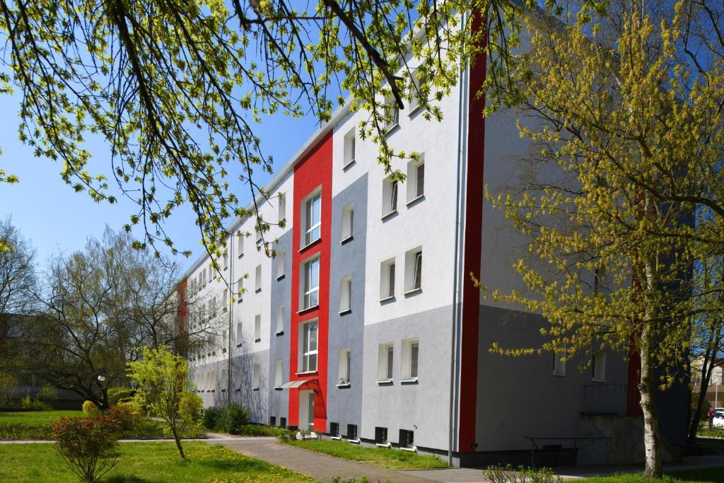a white and red building in a park at SKYBASIC Merseburg in Merseburg