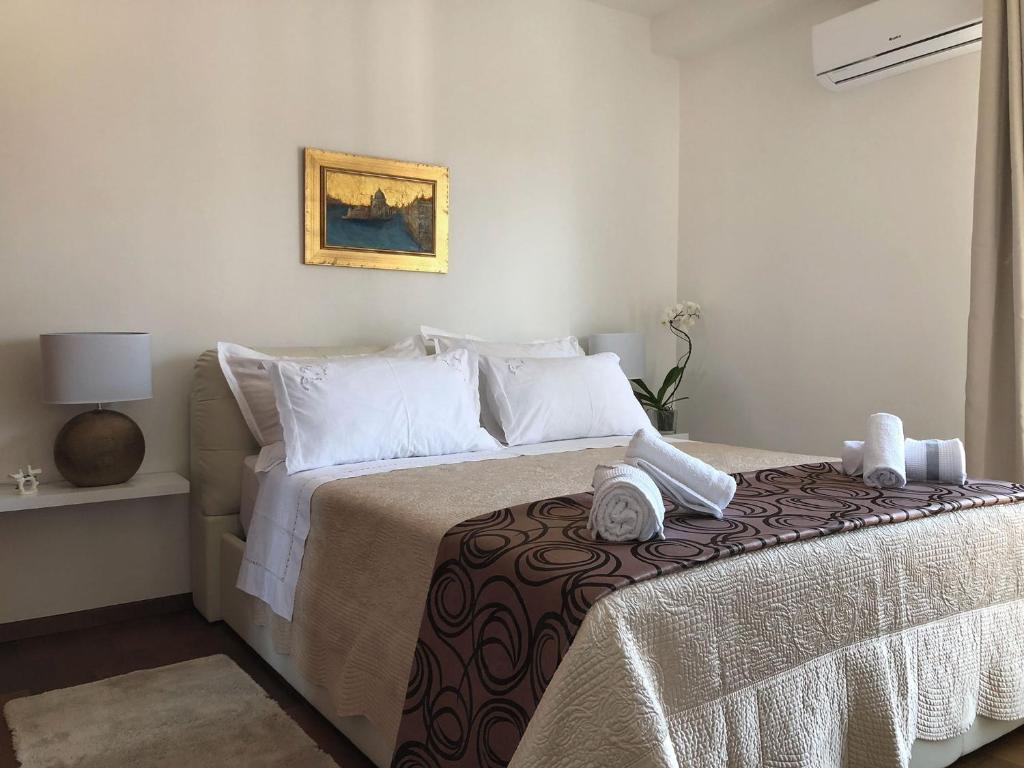 a bedroom with a bed with white sheets and white pillows at Apartment Marija in Split