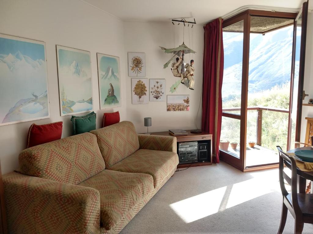 a living room with a couch and a table at Home ON SLOPES, the slope n°3 is under the balcony! in Breuil-Cervinia