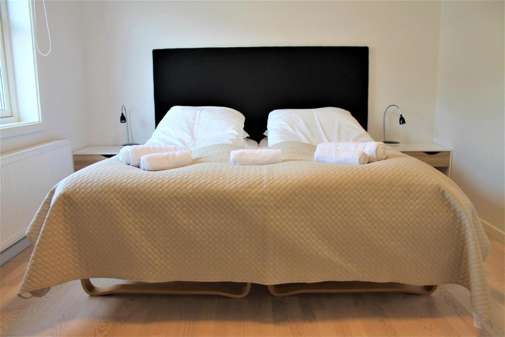 a bedroom with a large bed with two pillows at Hotel Nuka in Ilulissat
