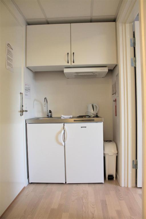 a kitchen with a counter and a sink in a room at Hotel Nuka in Ilulissat