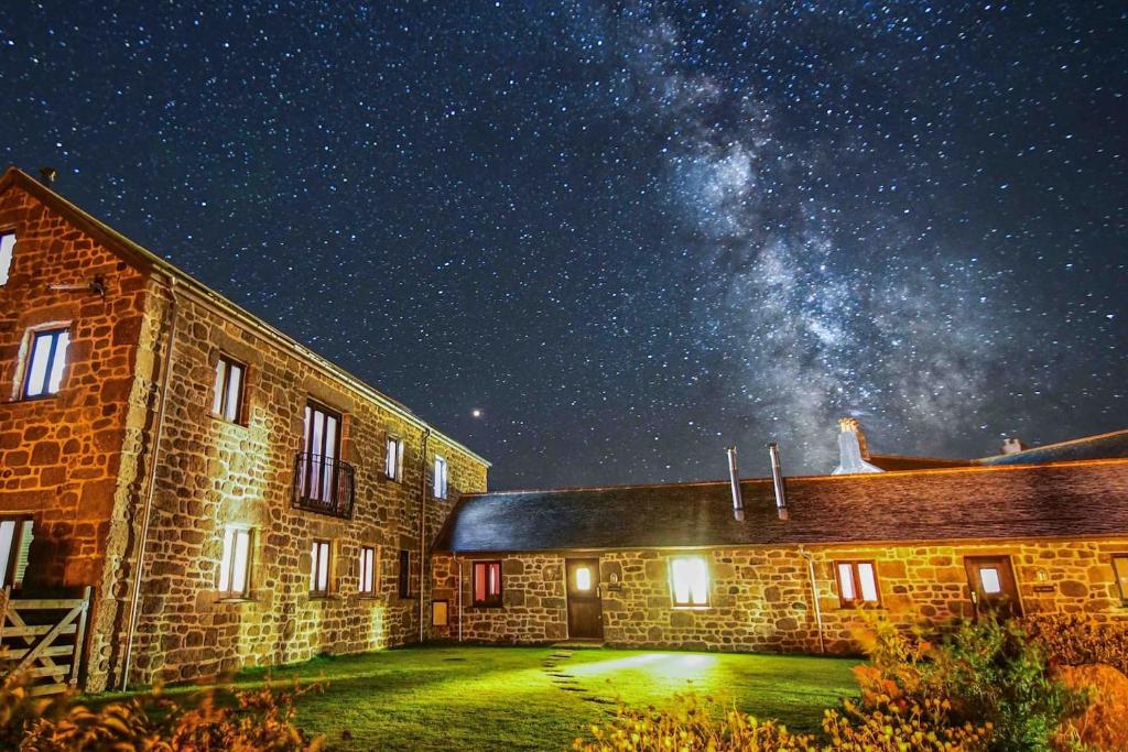a brick building with the milky way in the sky at Sennen Cove, The Hedgerows, near 14 beaches, in Penzance