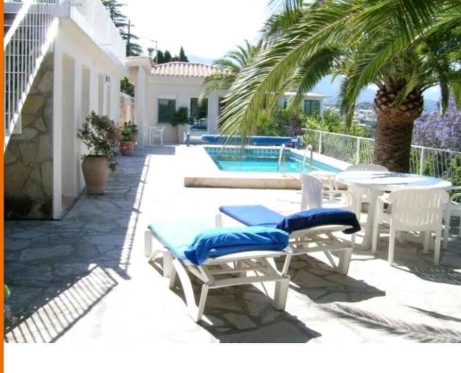 a patio with a table and chairs and a pool at Altea 1 in Altea