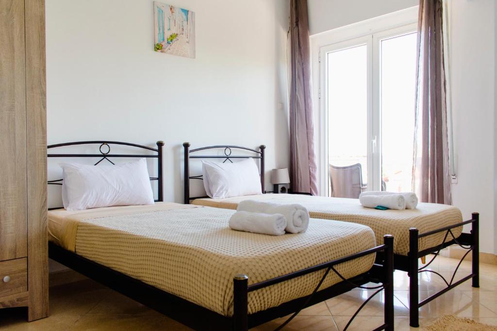 Postel nebo postele na pokoji v ubytování Nikolakakis Rooms Lavrio