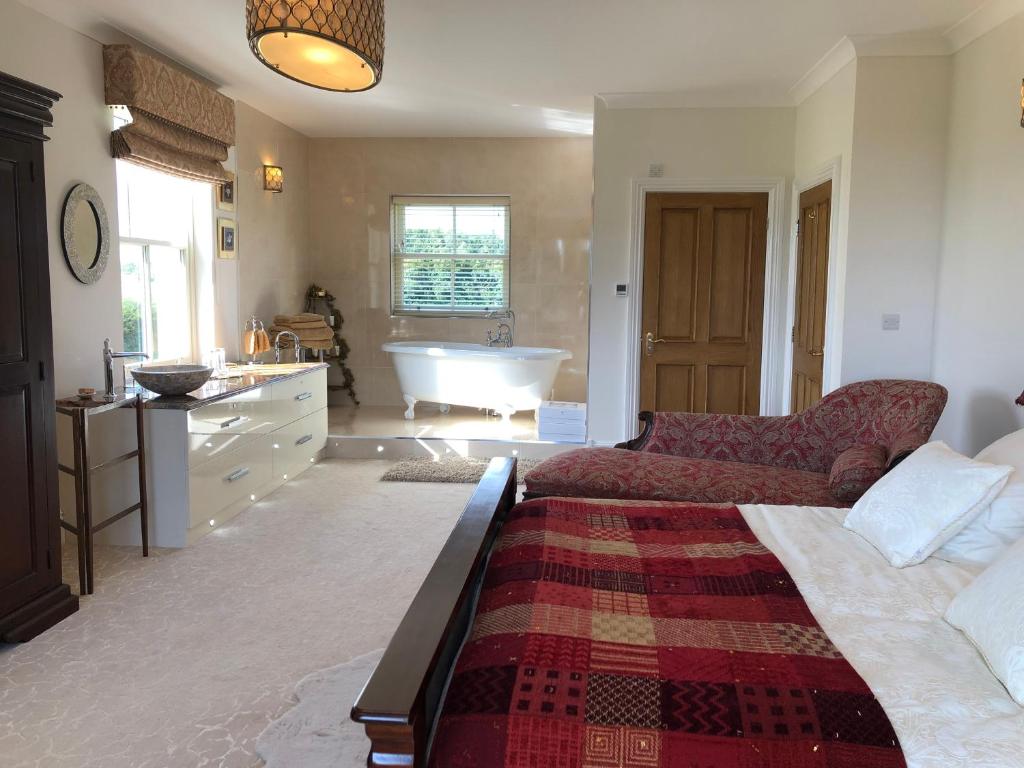 a living room with a bed and a bath tub at Lillium House in Stockton-on-Tees