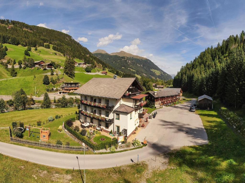 an aerial view of a house in a mountain at Hotel Garni Grünmoos in Sankt Jakob in Defereggen