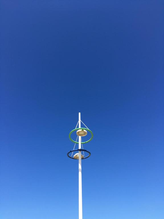 a street light with a blue sky in the background at Bel appartement Zeebruges in Zeebrugge