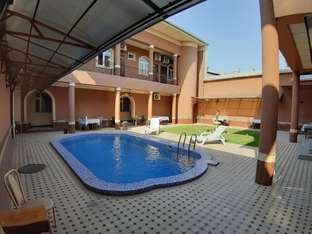 a swimming pool in the middle of a house at Sarbon Hotel Tashkent in Tashkent