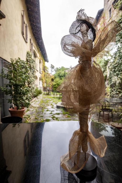 a statue of a woman in a dress on a table at Hotel Locanda Dei Mai Intees in Azzate